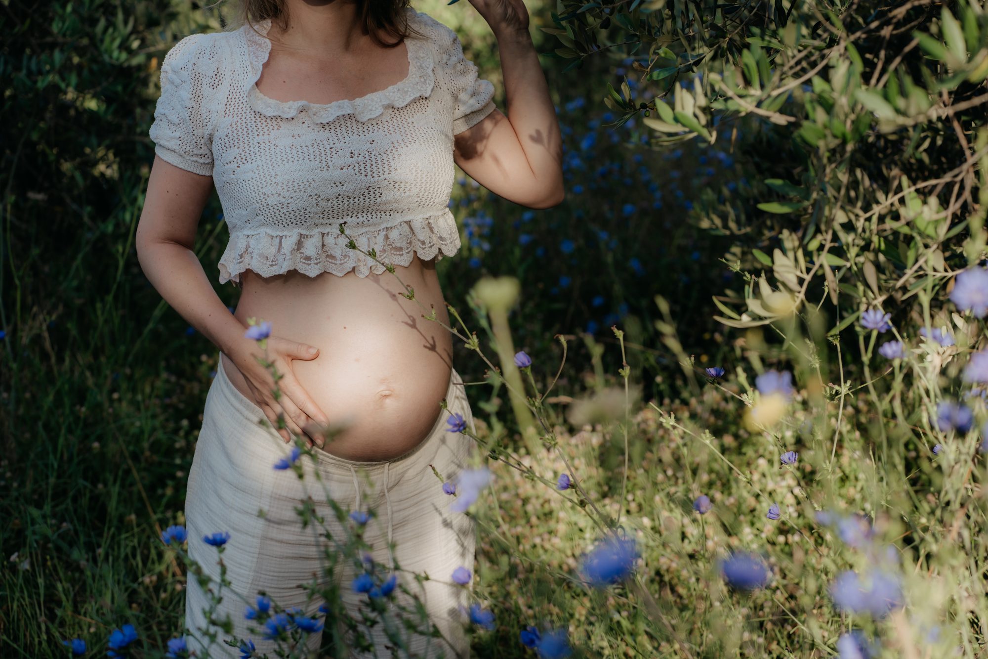 Schwangere mit Babybauch in der Wildblumenwiese — Babybauchfotografie